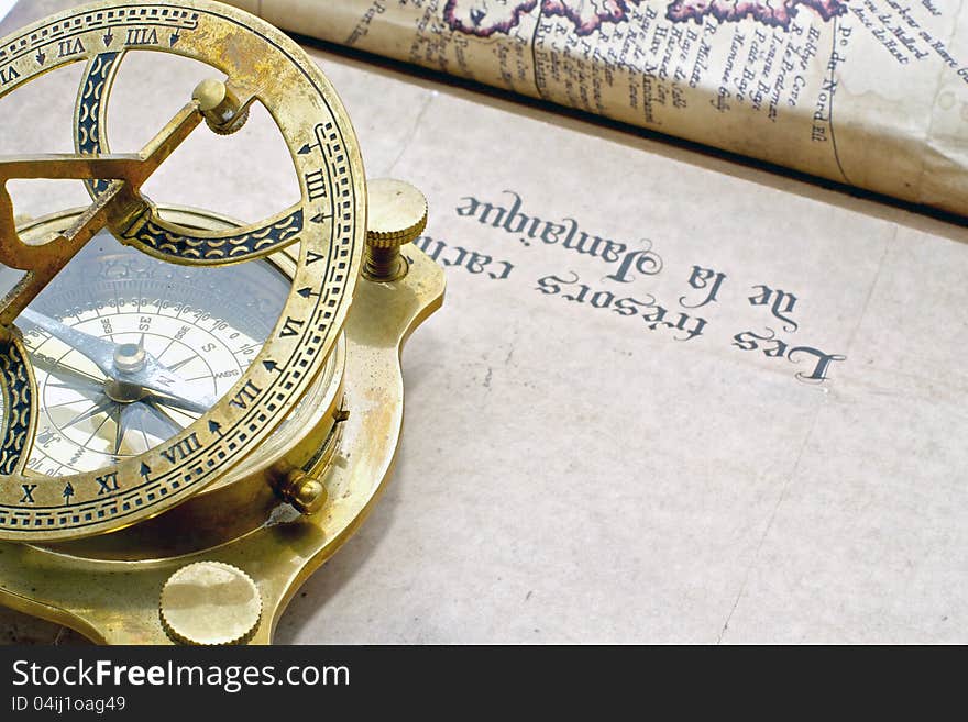 A antique compass on an old map