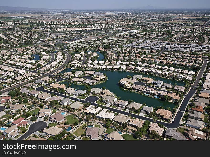 Aerial of suburban neighborhood with man made lake. Aerial of suburban neighborhood with man made lake