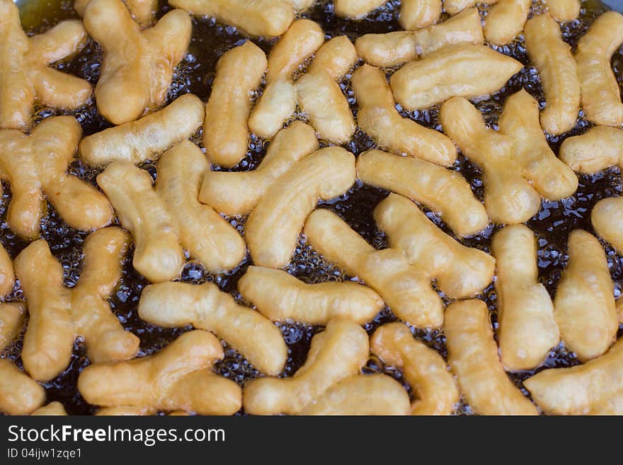 Closed-up deep-fried doughstick cooking