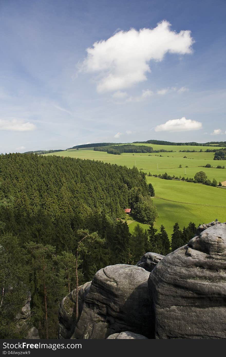 Summer landscape with rocks forests and meadows, rocky landscape in summer day with blue sky and clouds. Summer landscape with rocks forests and meadows, rocky landscape in summer day with blue sky and clouds