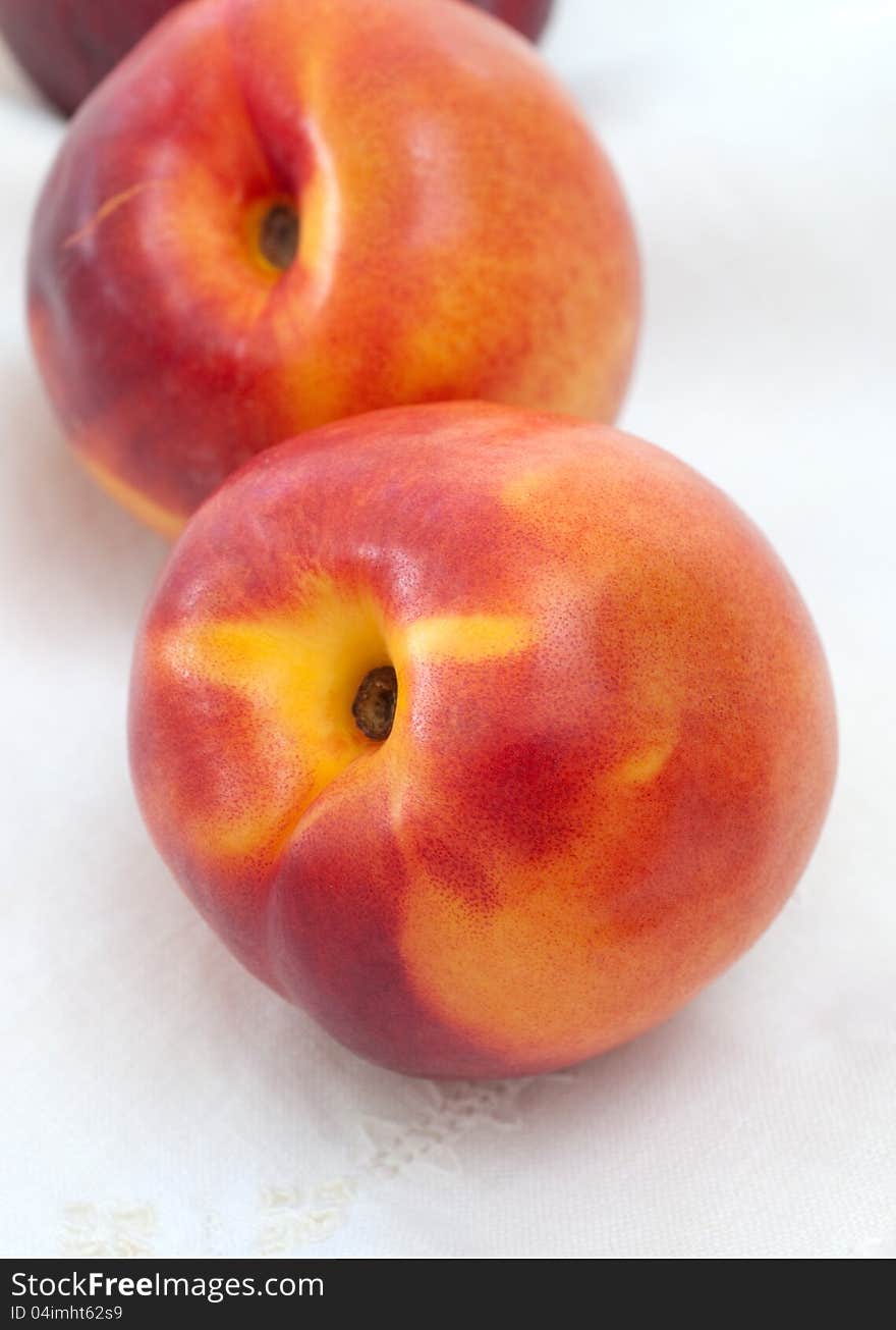 Two Nectarines And Embroidered Napkin