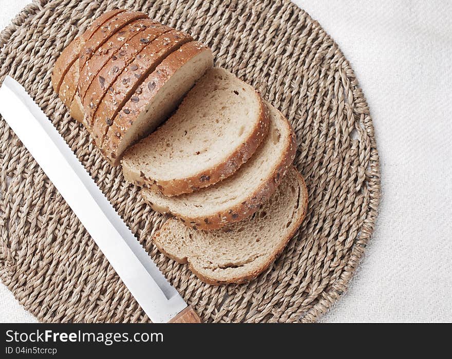 Sliced  bread and knife on wooden table