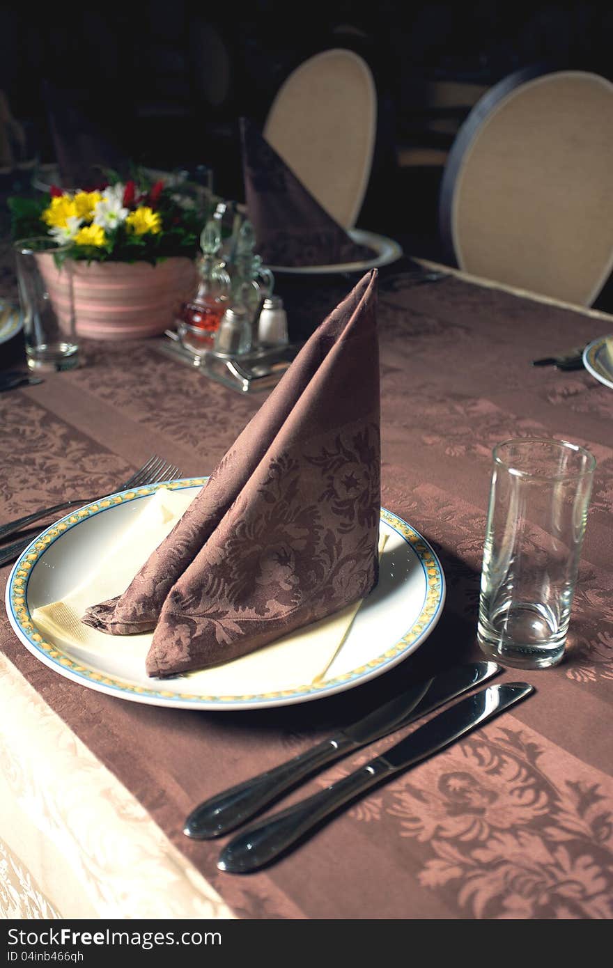 Plate and handkerchief served on a table in a hotel restaurant.