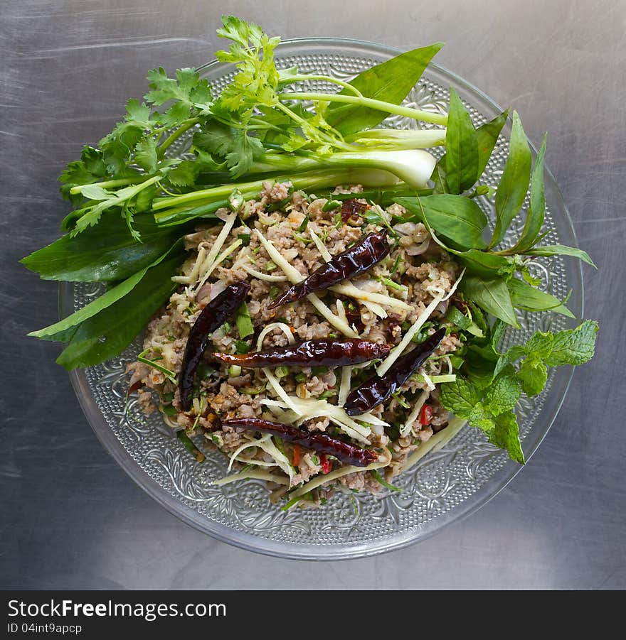 Pork with vegetables and pepper in a glass dish on a stainless steel and appetizing. Pork with vegetables and pepper in a glass dish on a stainless steel and appetizing.