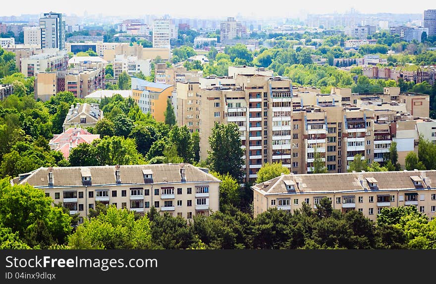 Buildings in a city in an environment of green trees. Buildings in a city in an environment of green trees