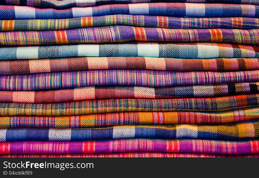 Stack Of Colorful Fabrics At Market