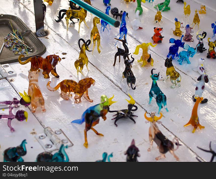 Colorful beautiful glass craft small animals figurines sculptures on display. Colorful beautiful glass craft small animals figurines sculptures on display