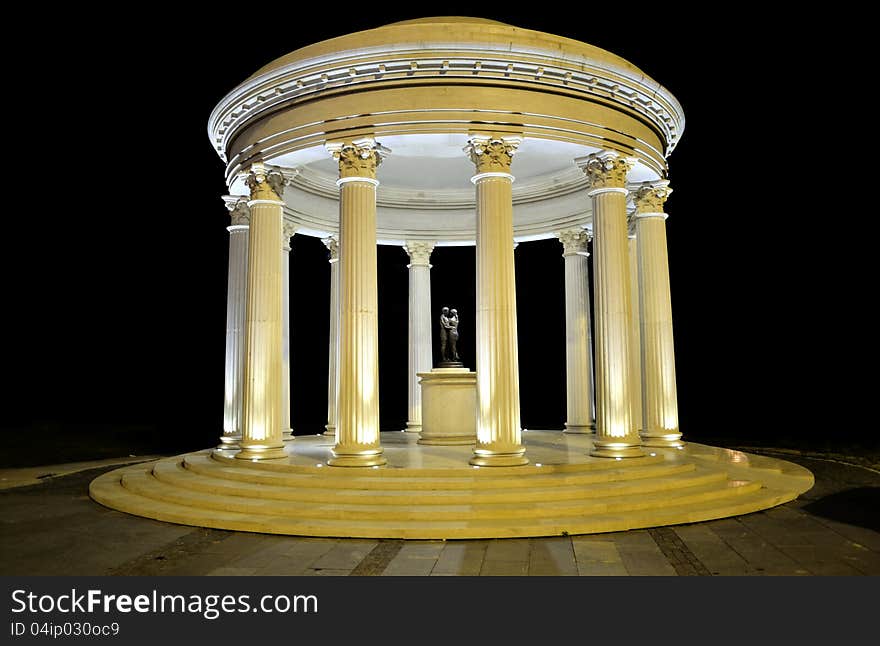 Monument at night with men and woman sculpture. Monument at night with men and woman sculpture