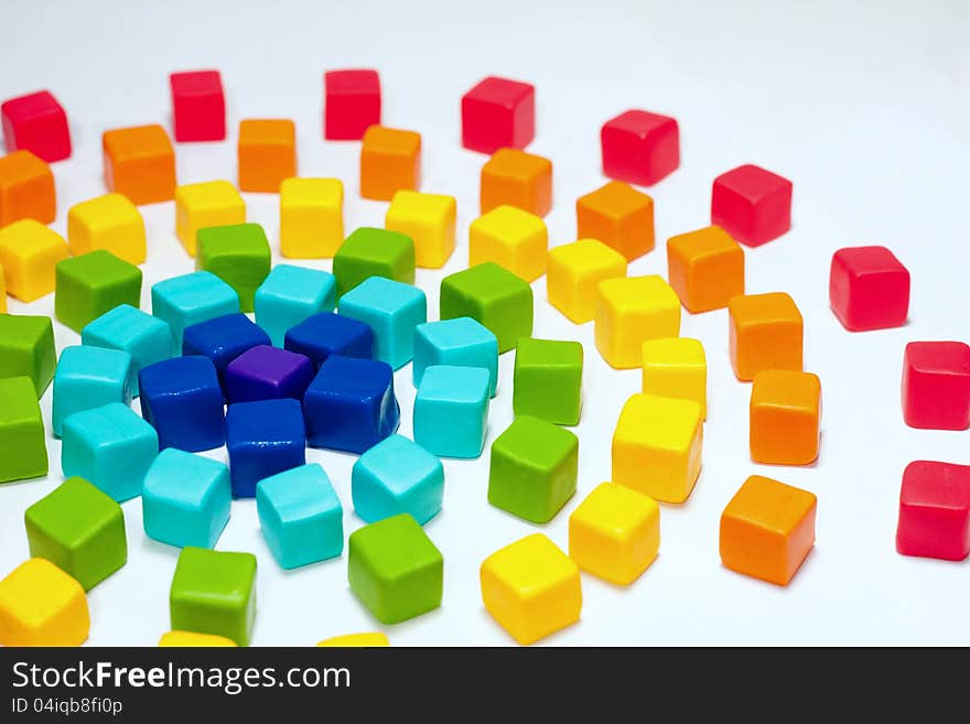 Colorful cubes with paste on background