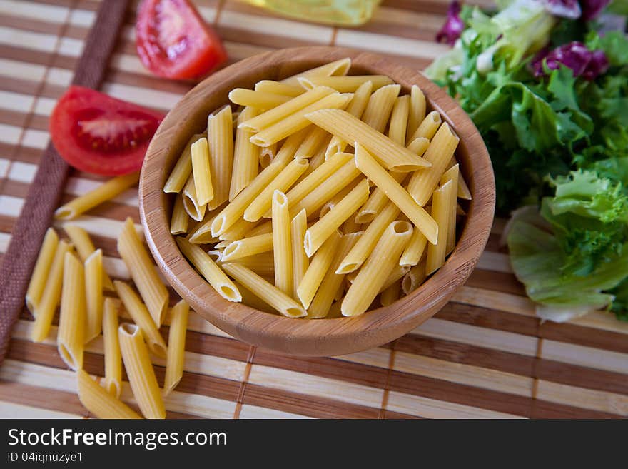 Uncooking pasta in bamboo bowl. Uncooking pasta in bamboo bowl.