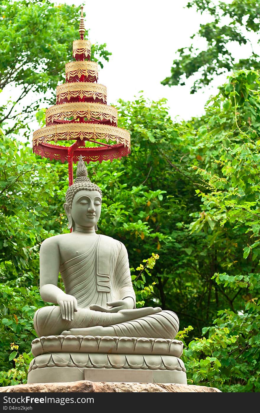 Buddha Image Made From Sand Stone with Trees