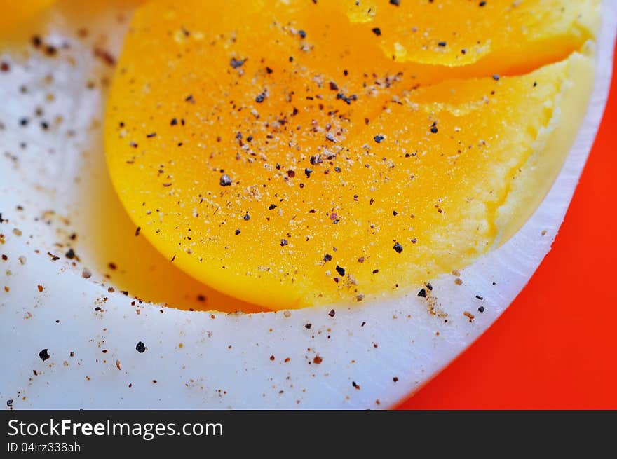 Super close up of boiled egg yolk with pepper