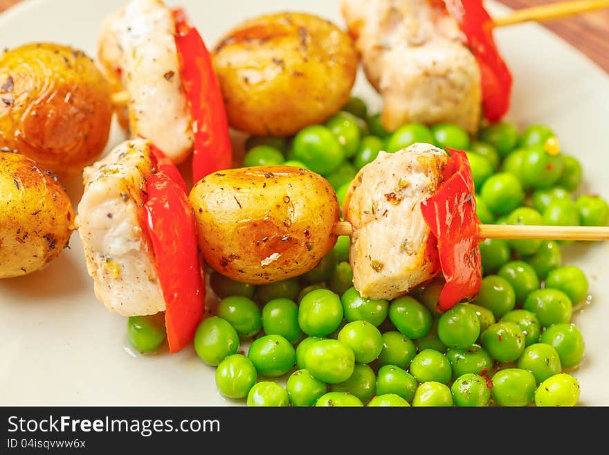 Grilled chicken with potatoes and peas, close up. Grilled chicken with potatoes and peas, close up