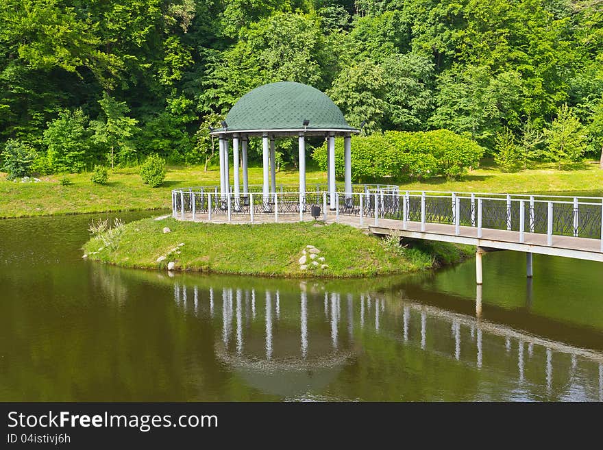 Bower on the small artificial island midst the pond in the Feofaniya park in Kiev. Bower on the small artificial island midst the pond in the Feofaniya park in Kiev