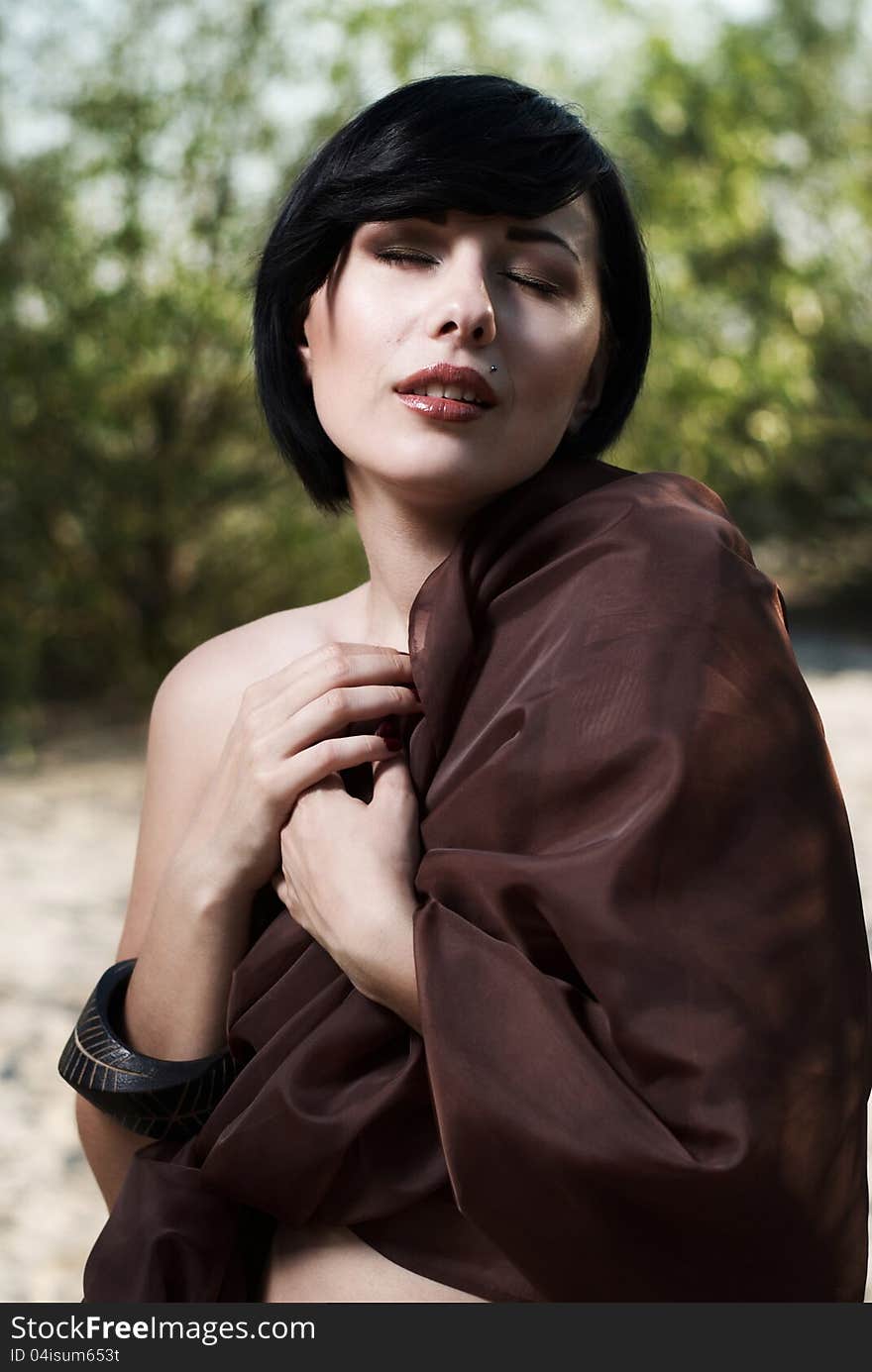 Girl posing in a tree shade