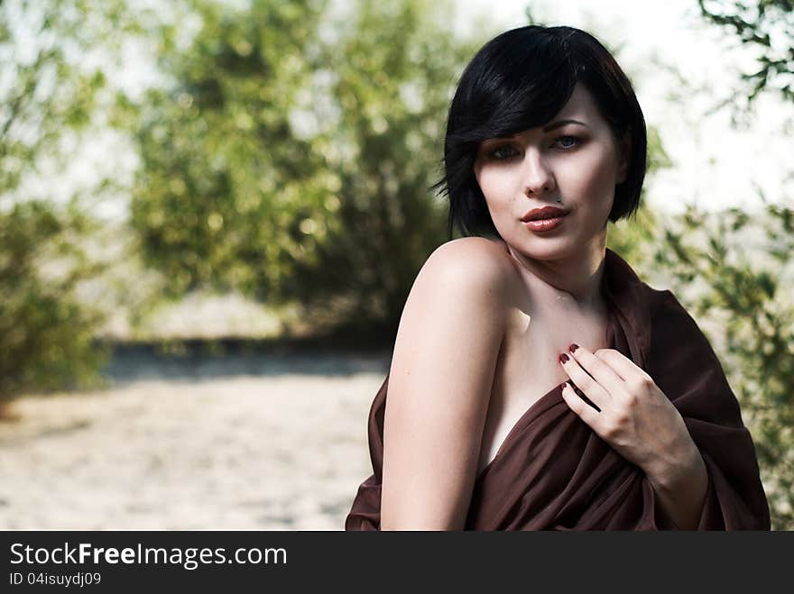 Girl posing in a tree shade