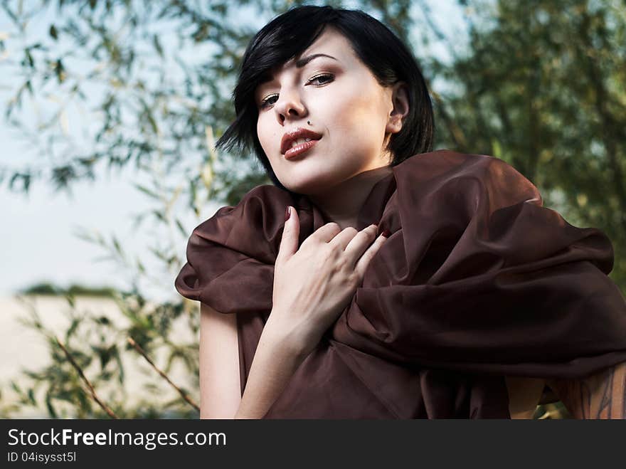 Girl posing in a tree shade