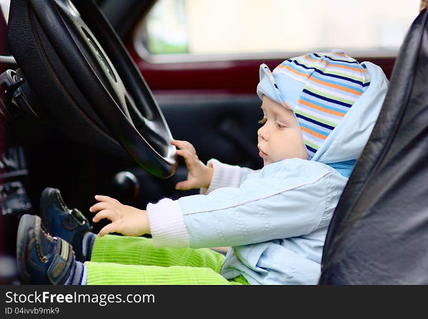 Little boy at driver seat with steering wheel