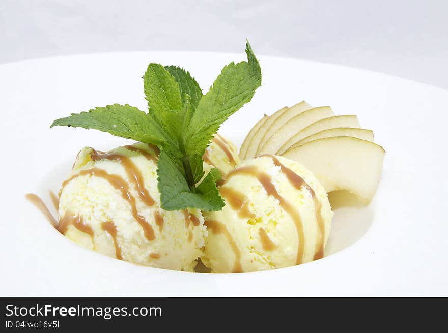 Ice cream with caramel sauce and mint on a white background. Ice cream with caramel sauce and mint on a white background