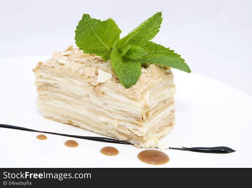 Ice cream with caramel sauce and mint on a white background. Ice cream with caramel sauce and mint on a white background