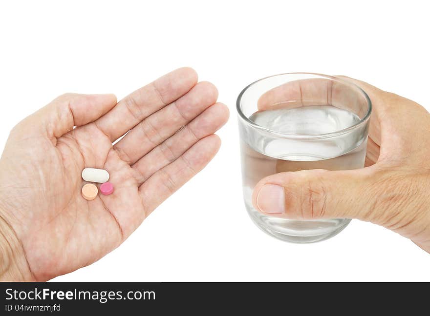 Pills and glass of water in hand isolated on white background