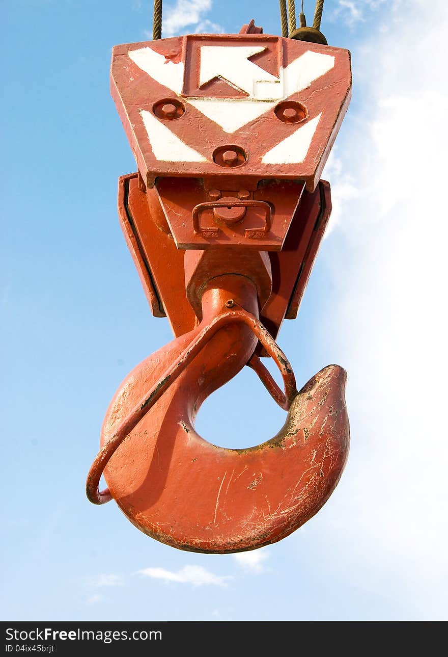 Hook of crane against the blue sky