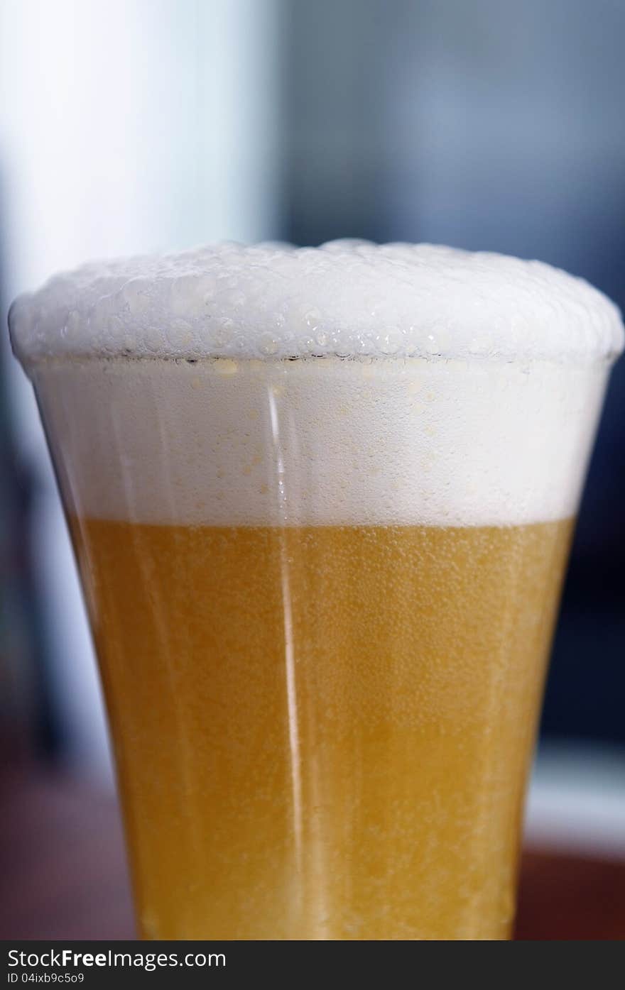 A glass of beer with foam