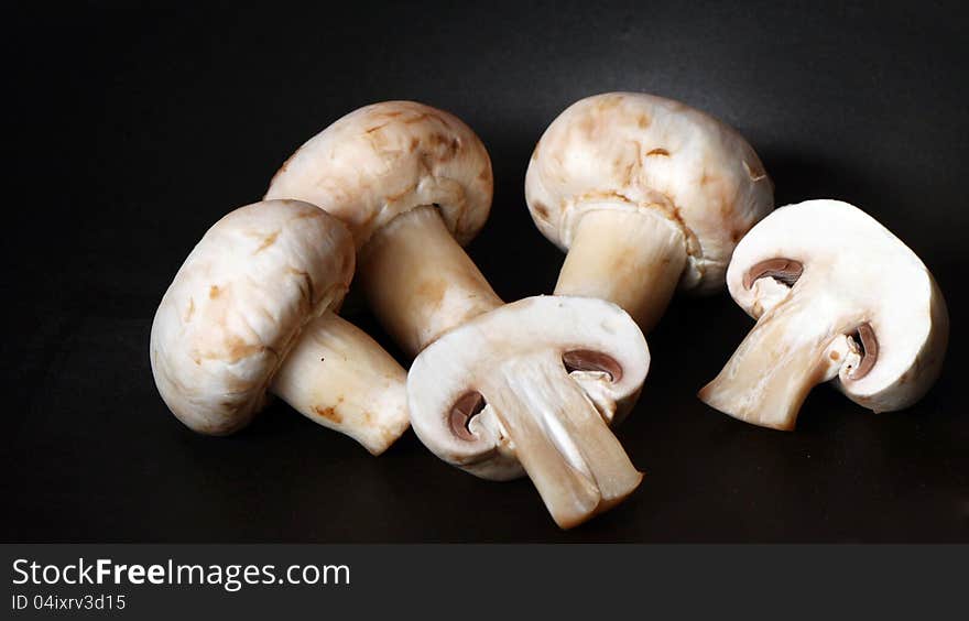 Isolated Raw Mushrooms  On Black Pan