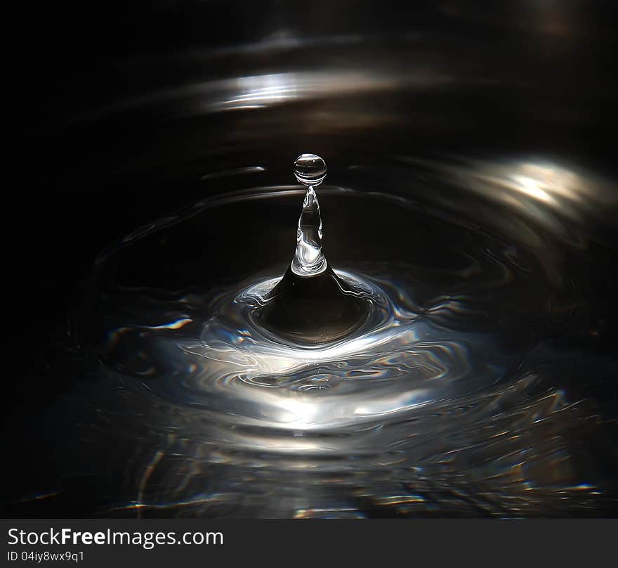 A small drop of water on the water surface