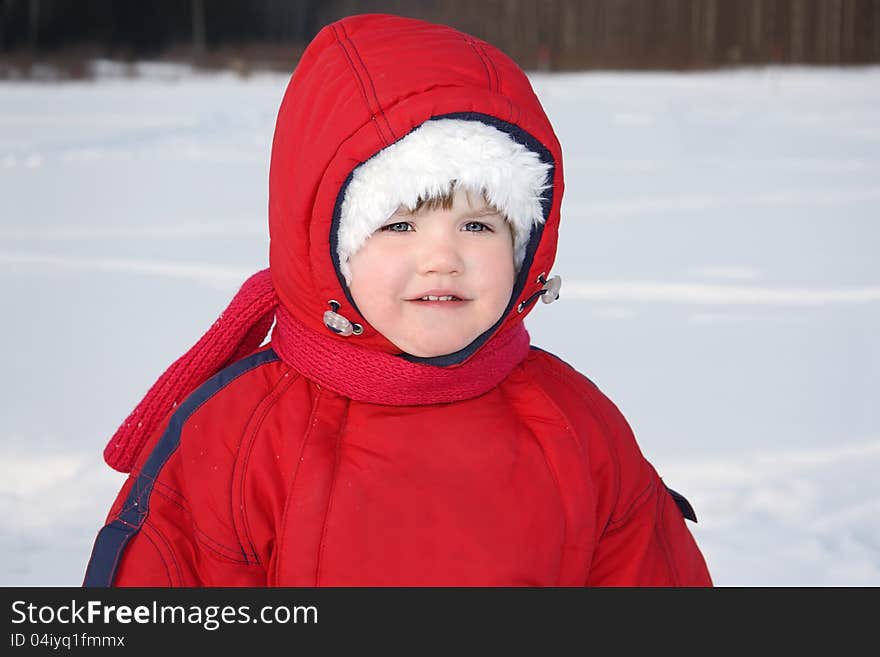 Little Girl Stands Near Forest At Winter