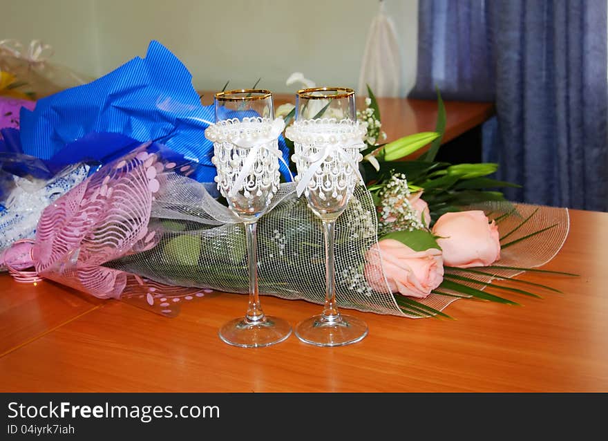 Two Decorated Wedding Glasses And Flowers