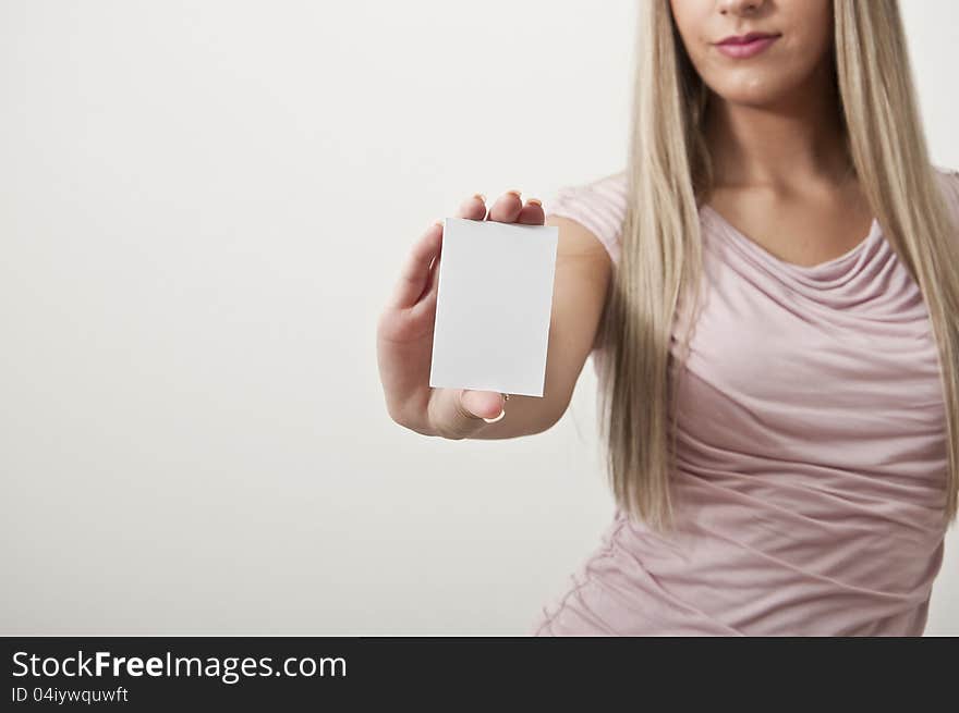 Beautiful business woman with white sign in hand isolated in a white background. Beautiful business woman with white sign in hand isolated in a white background