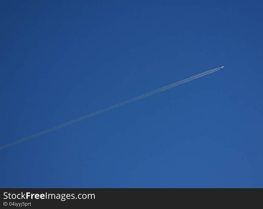 Single airplane in clear deep blue sky