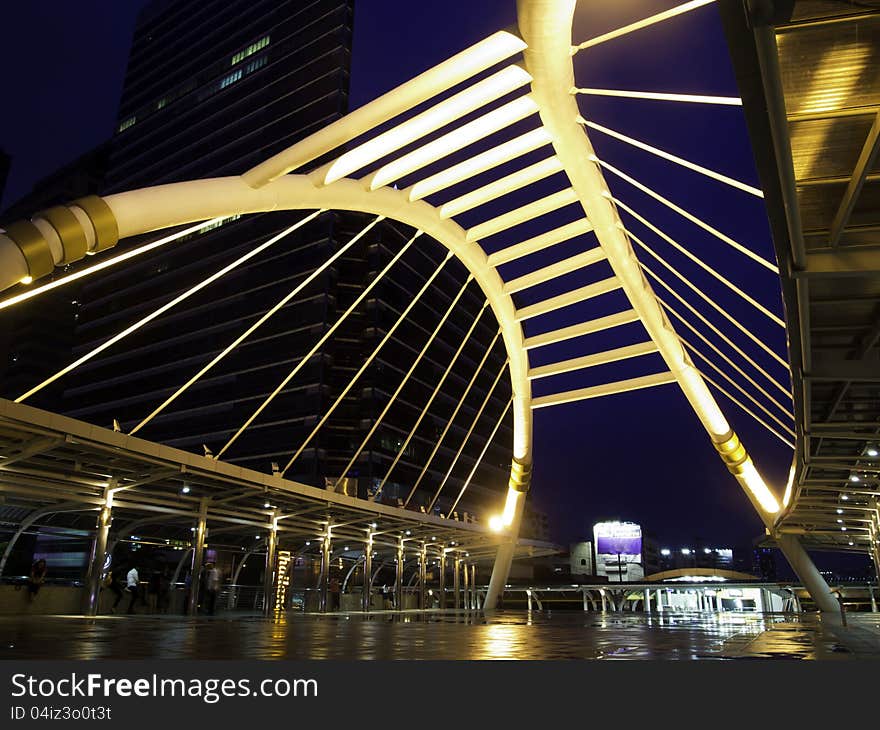 Pubic skywalk at bangkok downtown square night in business zone