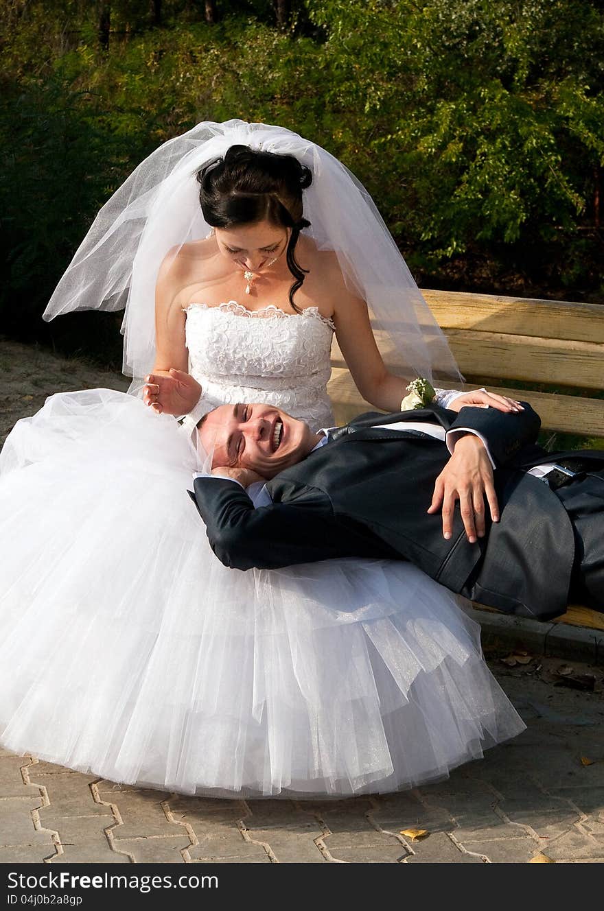 Just married young couple resting outdoors having fan