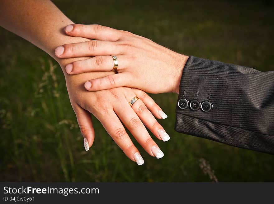 Wedding rings on their hands