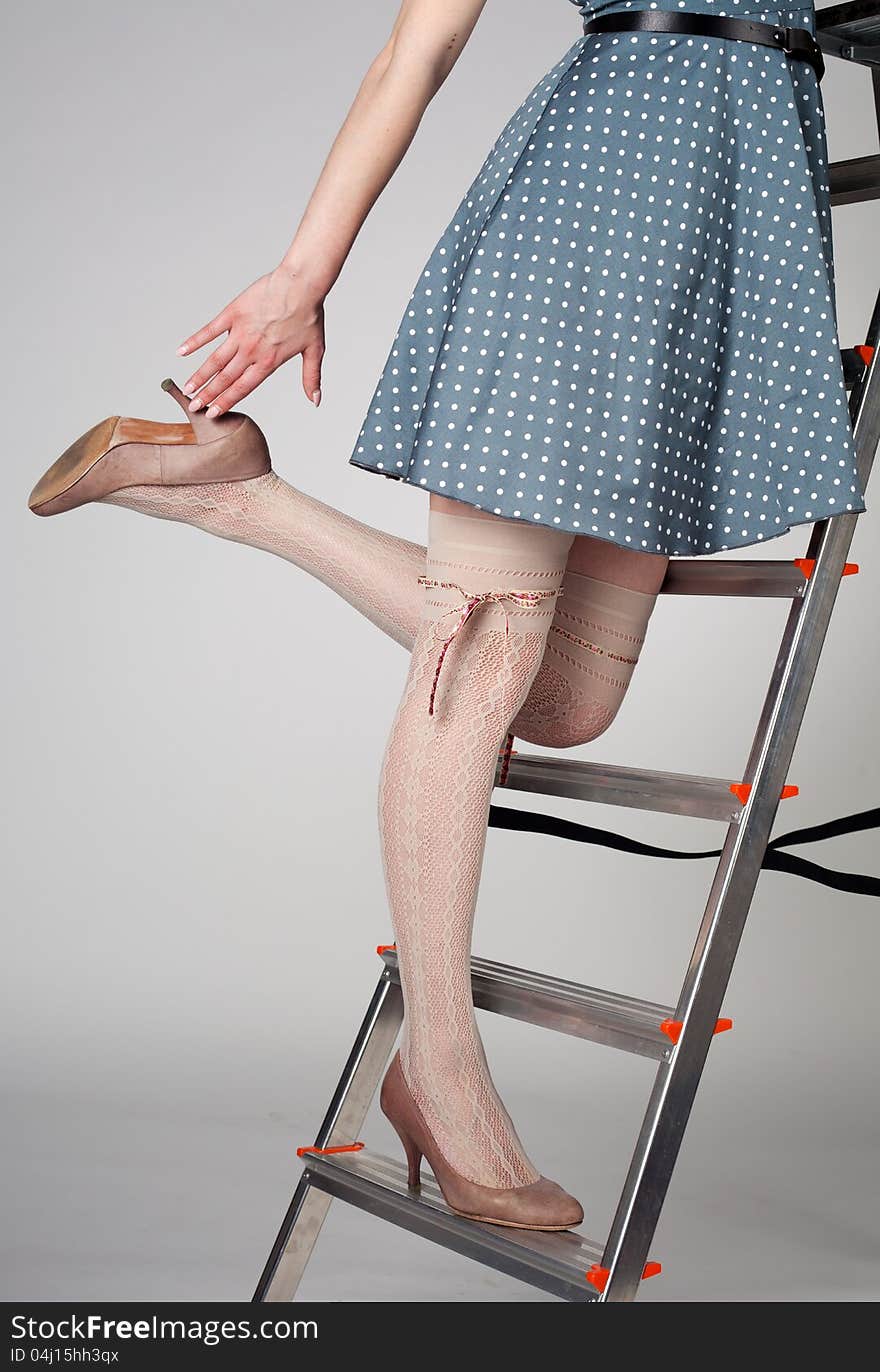 long female legs staying on the stairway in studio. long female legs staying on the stairway in studio