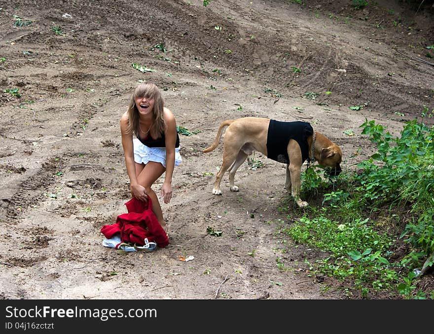 Young girl with her dog walking in city park