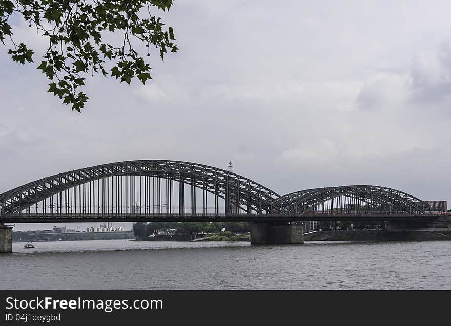 The Hohenzollern Bridge is a railway bridge which spans the River Rhine at the city of Cologne in the federal state of Northrhine-Westphalia in Germany. The bridge was constructed between 1907 and 1911. It was named after the House of Hohenzollern, one of Germany's great ruling families. The Hohenzollern Bridge is a railway bridge which spans the River Rhine at the city of Cologne in the federal state of Northrhine-Westphalia in Germany. The bridge was constructed between 1907 and 1911. It was named after the House of Hohenzollern, one of Germany's great ruling families.