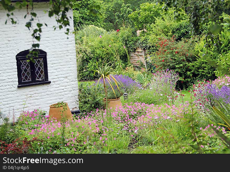 Photo of kent chateau nestling in beautiful lush landscape garden.