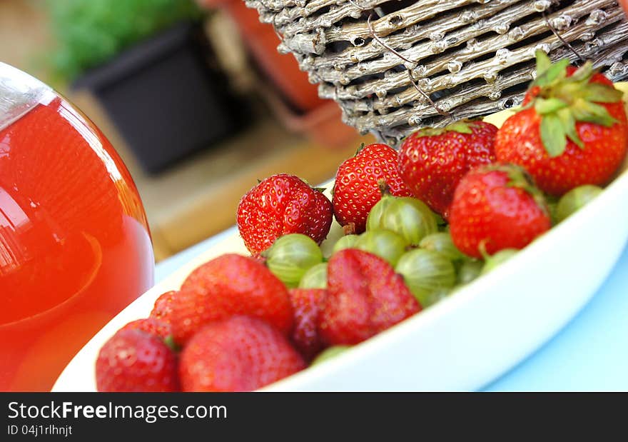 Strawberries, gooseberry, basket and compote