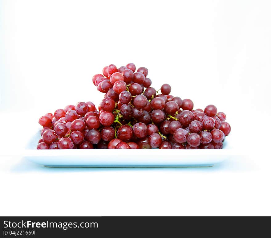 Fresh red delicious grapes on plate. Fresh red delicious grapes on plate