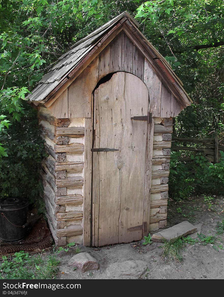 Old outhouse, with beam and plaster construction and wood shingles, sitting in the trees. Old outhouse, with beam and plaster construction and wood shingles, sitting in the trees.