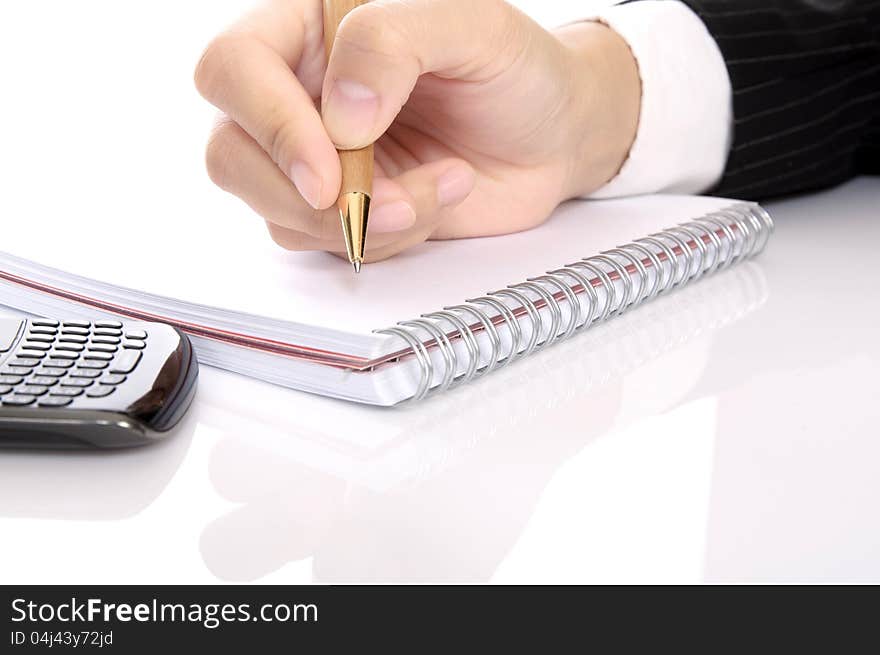 Business woman writing with pen on the notebook. Business woman writing with pen on the notebook