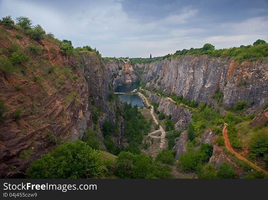 Artificial canyon (old mine) with a small lake. Artificial canyon (old mine) with a small lake