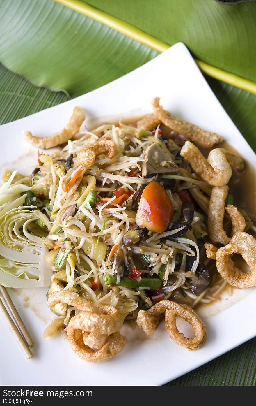 Mixed somtam,spicy papaya salad plate on banana leaf background