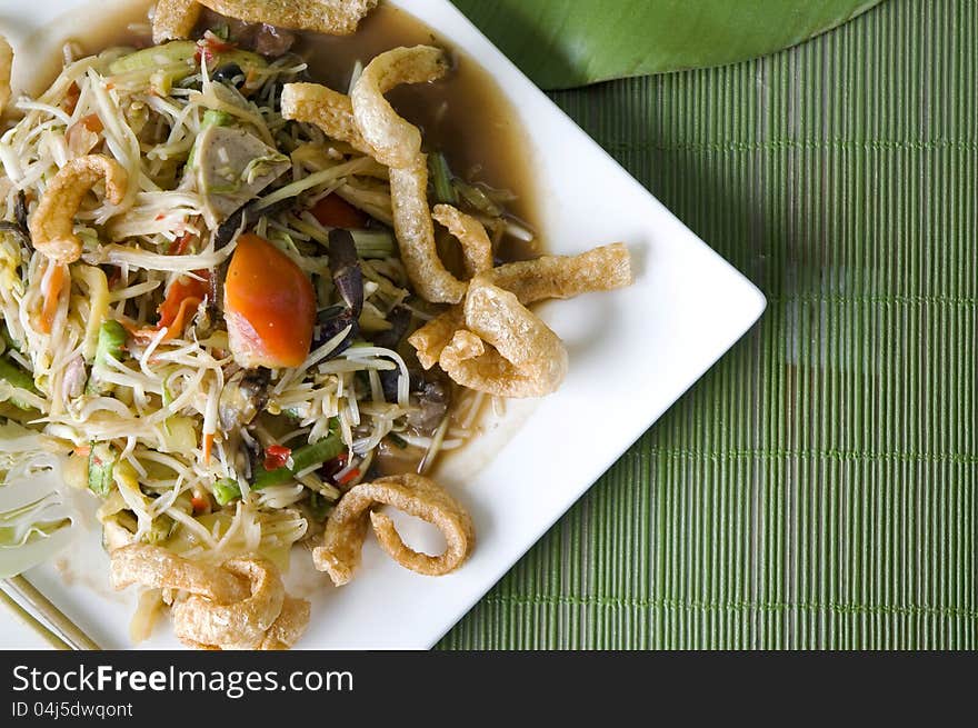 Spicy mixed papaya salad on white plate. Spicy mixed papaya salad on white plate