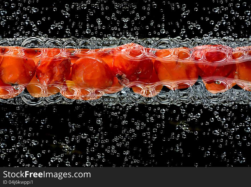 Red fruits on the water. Red fruits on the water.