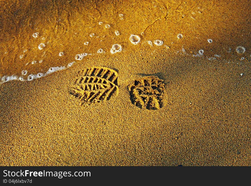 Print of the shoe on the sandy beach. Print of the shoe on the sandy beach.