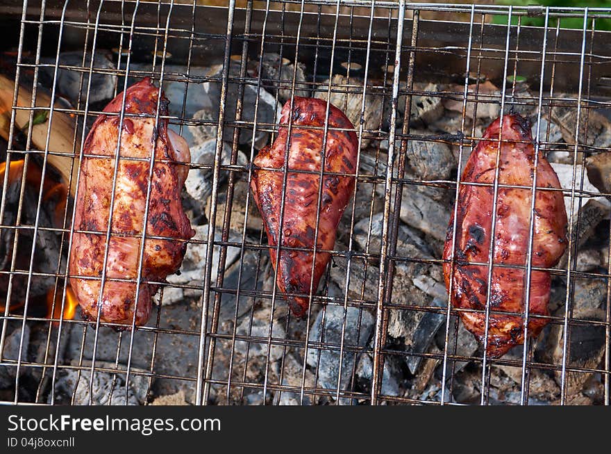 Barbecue.chicken on the grill with flames